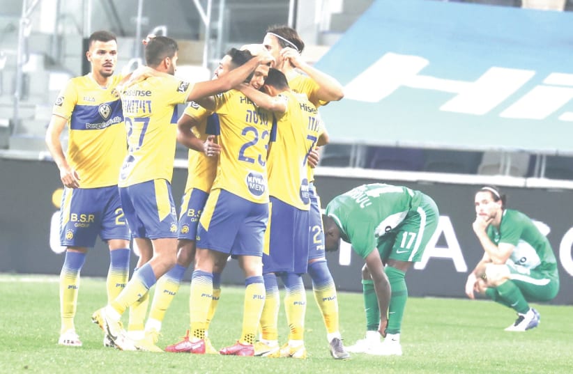 MACCABI TEL AVIV players celebrate after their injury-time winner secured a dramatic 2-1 win over Maccabi Haifa in Israeli Premier League action at Bloomfield Stadium.  (photo credit: DANNY MARON)
