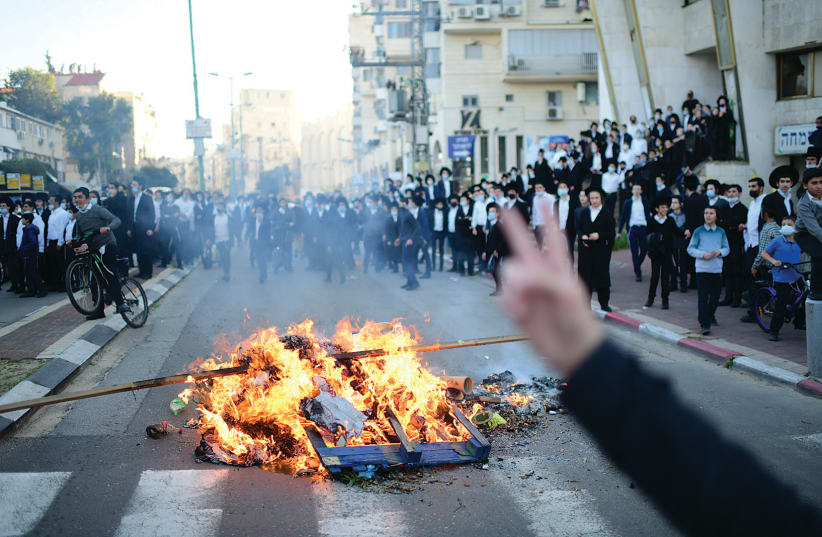 HAREDIM STAGE a fiery protest in Bnei Brak on Sunday. (photo credit: TOMER NEUBERG/FLASH90)