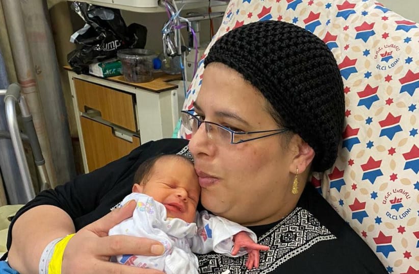 Noa Oz, with her baby, after being sedated and ventilated for seven weeks due to coronavirus complications, January 29, 2021.  (photo credit: HADASSAH SPOKESPERSON)