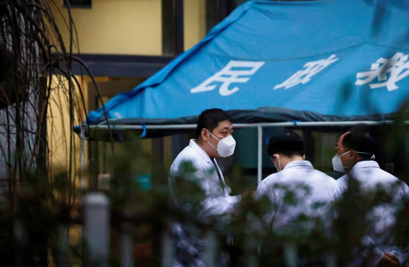 WHO team member at a hospital in Wuhan (photo credit: REUTERS)