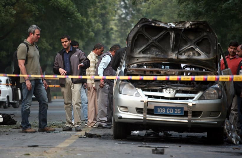 People examine a damaged Israeli embassy car after an explosion in New Delhi in 2012. (photo credit: REUTERS/PARIVARTAN SHARMA)