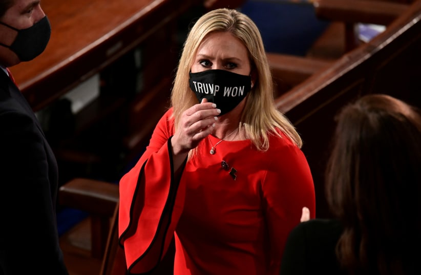 US Rep. Marjorie Taylor Greene (R-GA) wears a "Trump Won" face mask as she arrives on the floor of the House to take her oath of office as a newly elected member of the 117th House of Representatives in Washington, US, January 3, 2021.  (photo credit: REUTERS/ERIN SCOTT/POOL/FILE PHOTO)