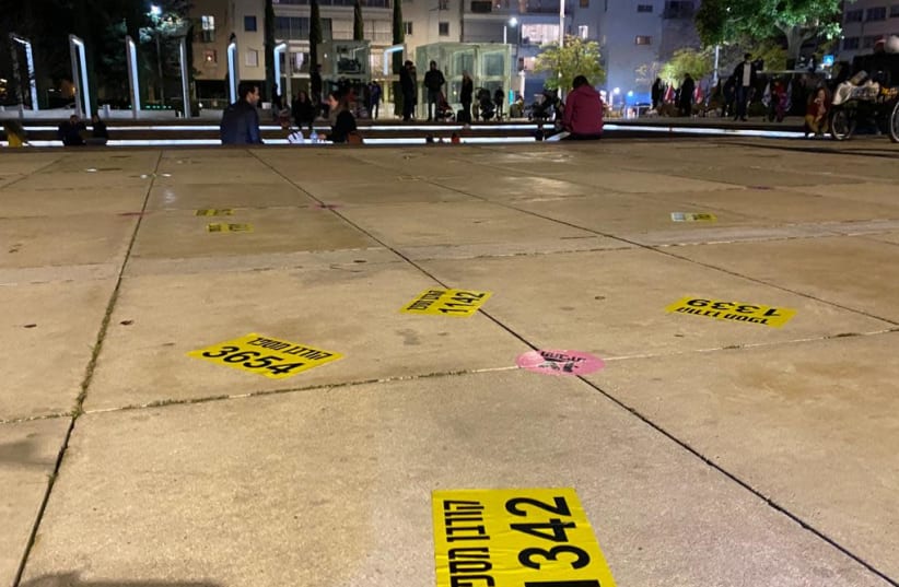 Notes scattered throughout Habima Square in Tel Aviv by protesters, symbolizing the 4,600 victims of the coronavirus in Israel, Saturday, January 30, 2021. (photo credit: SASSONI AVSHALOM)