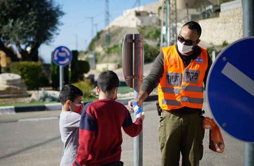 Soldiers from the IDF's Home Front Command unit distribute informative pamphlets in Arabic (photo credit: IDF SPOKESPERSON'S UNIT)