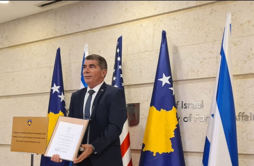 Foreign Minister Gabi Ashkenazi is seen with the agreement to form diplomatic ties with Kosovo in front of the Foreign Ministry in Jerusalem, on February 1, 2021. (photo credit: FOREIGN MINISTRY)