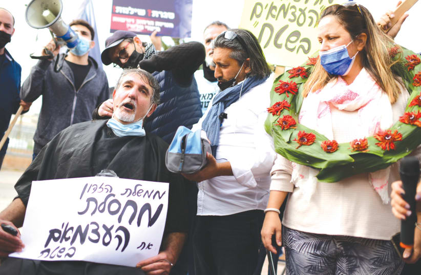 SMALL-BUSINESS owners protest coronavirus restrictions, in Holon, on January 31. (photo credit: TOMER NEUBERG/FLASH90)