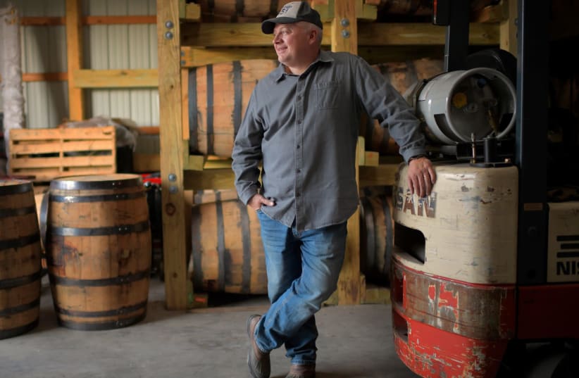 Former congressman Denver Riggleman in his barrel barn, where he ages spirits from the Virginia distillery that he co-owns with his wife, Nov. 20, 2020 (photo credit: JOHN MCDONNELL/THE WASHINGTON POST VIA GETTY IMAGES)