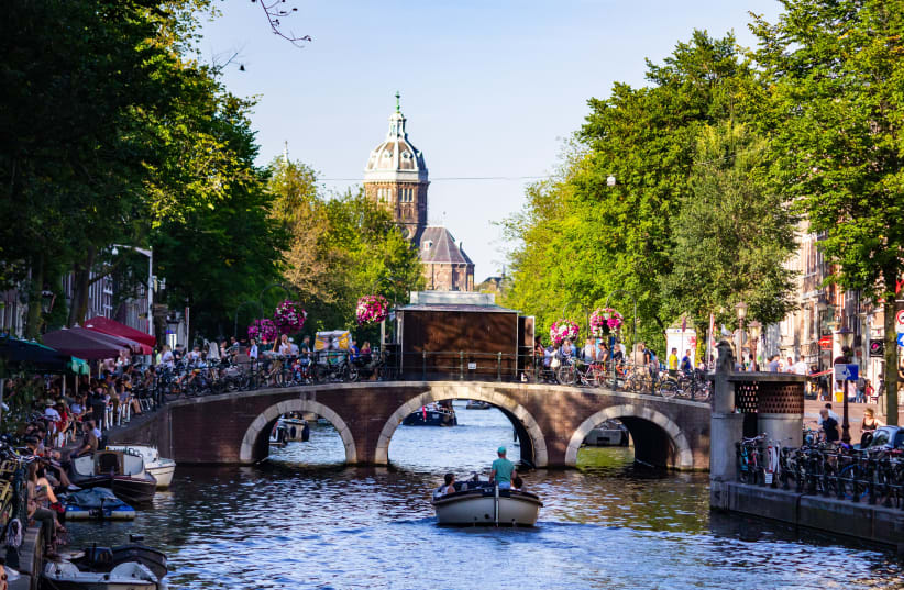 AMSTERDAM CANAL: At about 2 meters below sea-level, the city is built on 11 million support poles (photo credit: GAUTAM KRISHNAN /UNSPLASH)