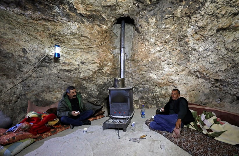 Palestinian cave-dwellers worry over Israeli settler incursions (photo credit: MUSSA QAWASMA/REUTERS)
