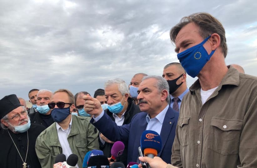 Palestinian Authority President Mohammed Shtayyeh is seen alongside EU Representative Sven Kühn von Burgsdorff is seen at the site of the illegal village of Khirbet Humsa, which the IDF demolished, on February 4, 2021. (photo credit: TOVAH LAZAROFF)