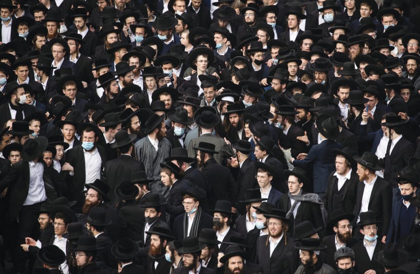 THE FUNERAL of Rabbi Meshulam Dovid Soloveitchik, on Sunday, in Jerusalem. The failure of haredi communities to come to terms with COVID-19, leading to extraordinary high rates of illness and death, requires soul-searching both internally and externally. (photo credit: YONATAN SINDEL/FLASH 90)