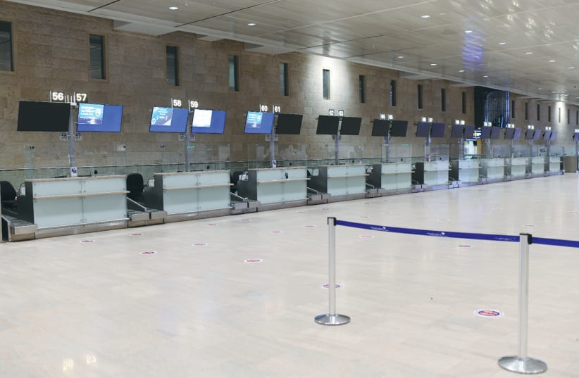 THE EMPTY departures hall at Ben-Gurion Airport this week. When will the skies open up and how long will it take until traveling is safe? (photo credit: TOMER NEUBERG/FLASH90)