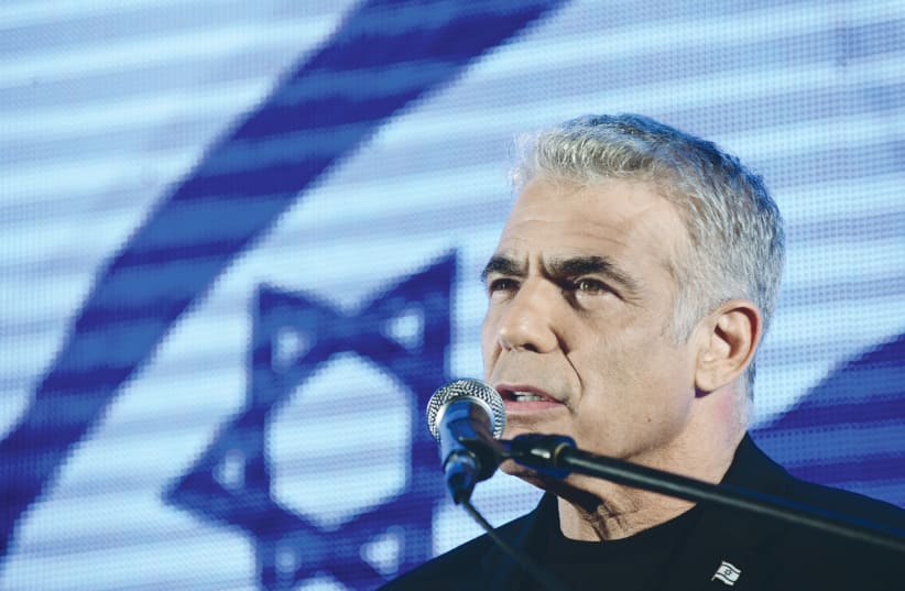 YESH ATID leader Yair Lapid speaks during a protest against Prime Minister Benjamin Netanyahu last year at Rabin Square in Tel Aviv.  (photo credit: TOMER NEUBERG/FLASH90)