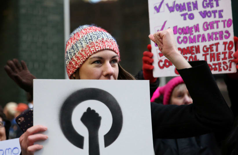 Amy Bettys, co-chair of the Women's Health and Reproductive Rights organization, raises her fist during a chant outside of New York Governor Andrew Cuomo's office in support of the Reproductive Health Act during a Reproductive Rights rally in the Manhattan borough of New York, US, March 22, 2017.  (photo credit: REUTERS/ASHLEE ESPINAL)