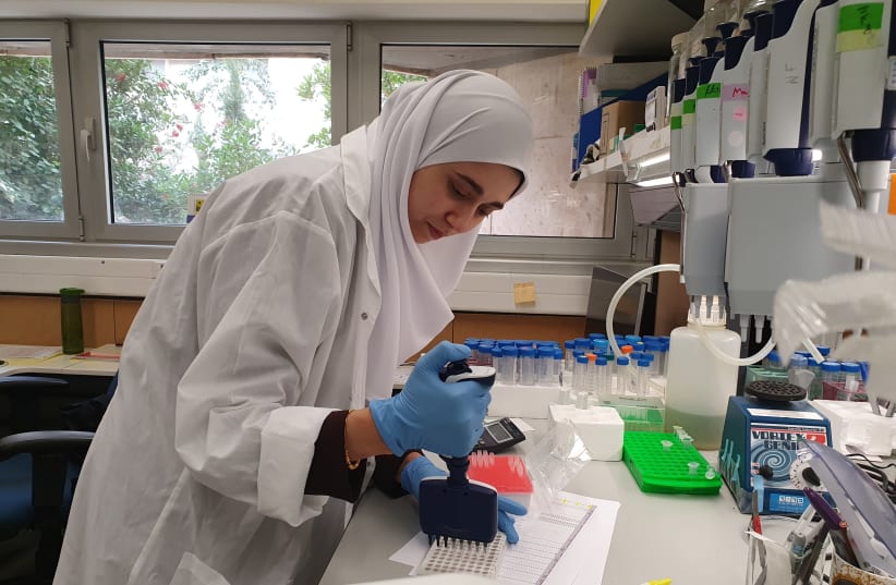 Dr. Israa Sharkiya at the Hebrew University lab, working on the new blood test technology.  (photo credit: COURTESY OF HEBREW UNIVERSITY)