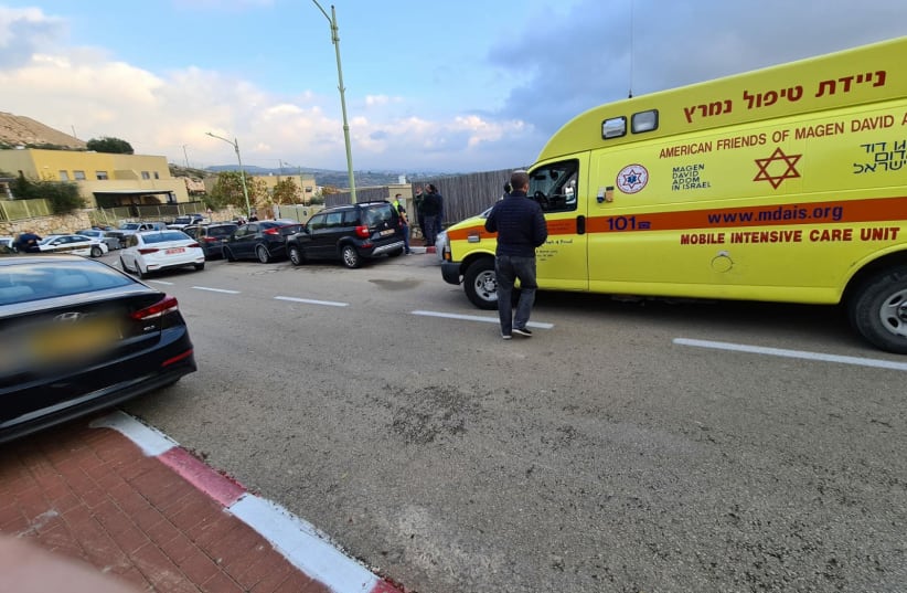 An MDA ambulance stands outside the home of a woman who was seemingly murdered by her husband (photo credit: MAGEN DAVID ADOM)
