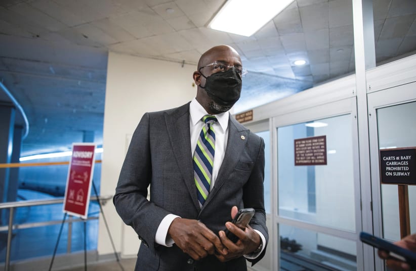 GEORGIA DEMOCRATIC Sen. Raphael Warnock departs following a vote in the basement of the US Capitol last month. (photo credit: AL DRAGO/REUTERS)