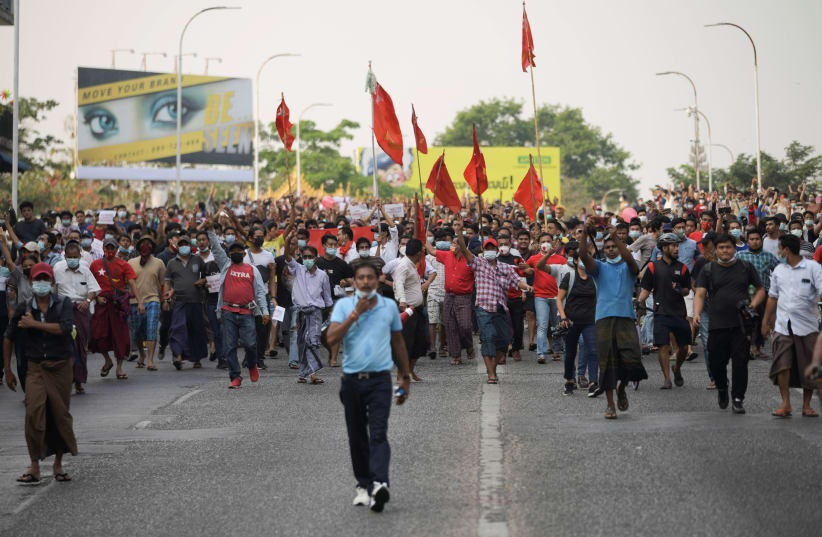 Demonstrators protest against the military coup and demand the release of elected leader Aung San Suu Kyi, in Yangon, Myanmar, February 6, 2021. (photo credit: REUTERS/STRINGER)
