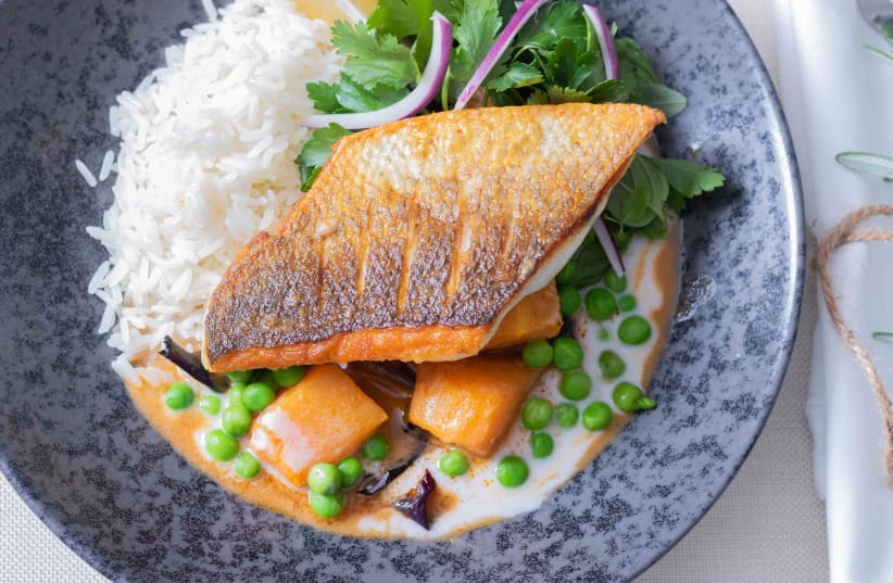 Fillet of fish over a bed of chestnut curry with pumpkin, peanut butter, peas and aromatic greens (photo credit: MARINA LEVDEV)
