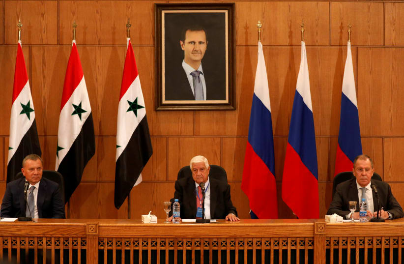 Russian Deputy Prime Minister Yuri Borisov, Foreign Minister Sergei Lavrov, and Syria's Foreign Minister Walid Muallem attend a press conference in Damascus, Syria, September 7, 2020 (photo credit: REUTERS/OMAR SANADIKI)