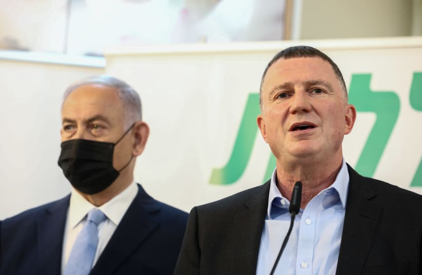 Health Minister Yuli Edelstein and Prime Minister Benjamin Netanyahu are seen speaking at a Clalit vaccination center in Zarzir, on February 9, 2021. (photo credit: DAVID COHEN/FLASH 90)