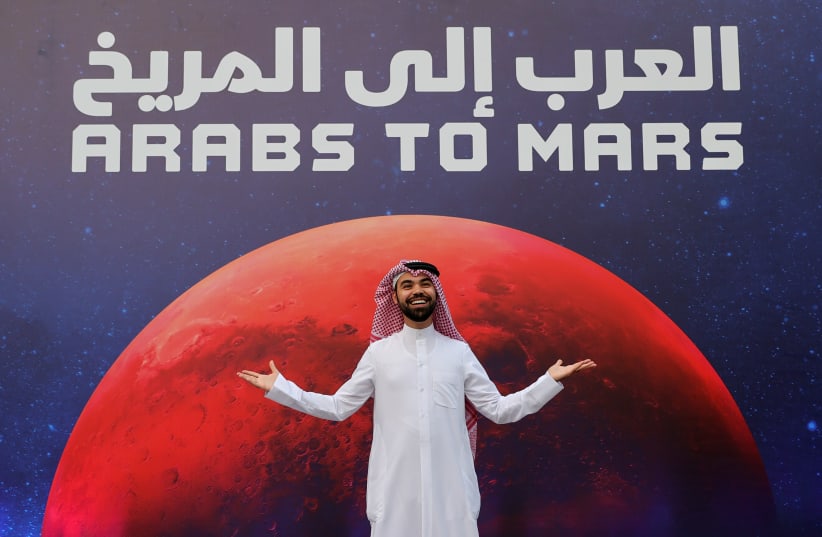 An attendee poses as he arrives to an event to mark Hope Probe's entering the orbit of Mars, in Dubai, United Arab Emirates, February 9, 2021.  (photo credit: REUTERS/CHRISTOPHER PIKE)