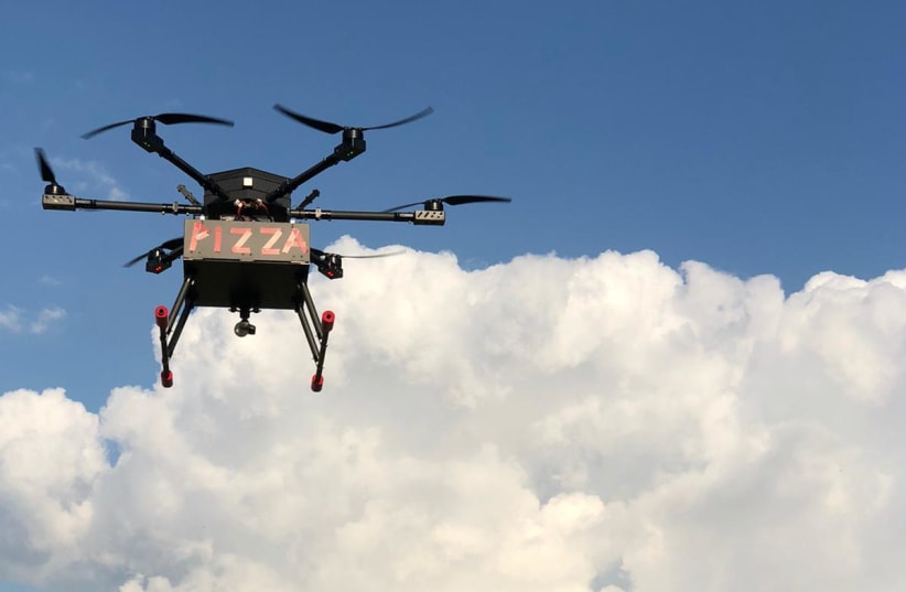 A drone delivers pizza in a pilot project commissioned by Israel's government. (photo credit: CANDO)