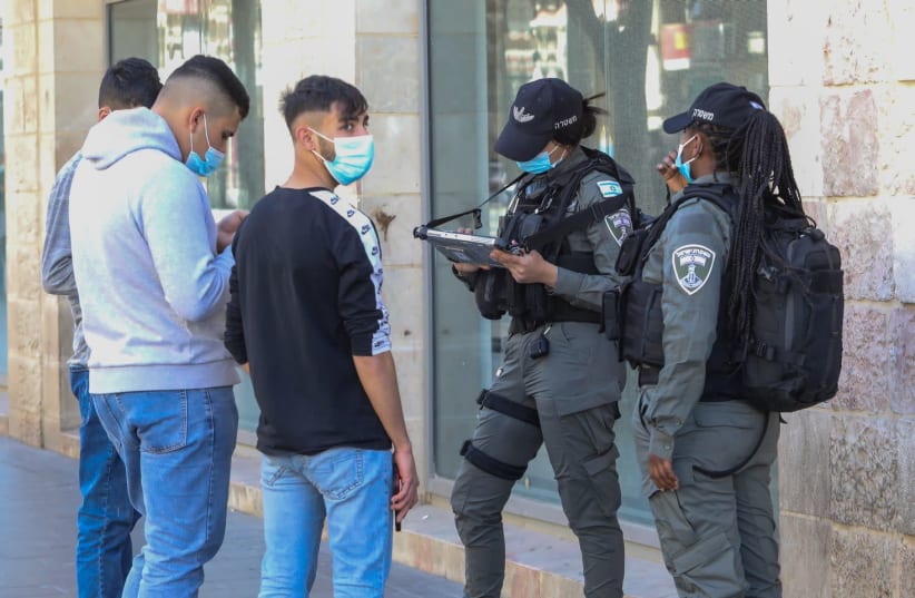 Police are seen on Jerusalem's Jaffa Street amid the coronavirus pandemic, on February 10, 2021. (photo credit: MARC ISRAEL SELLEM/THE JERUSALEM POST)