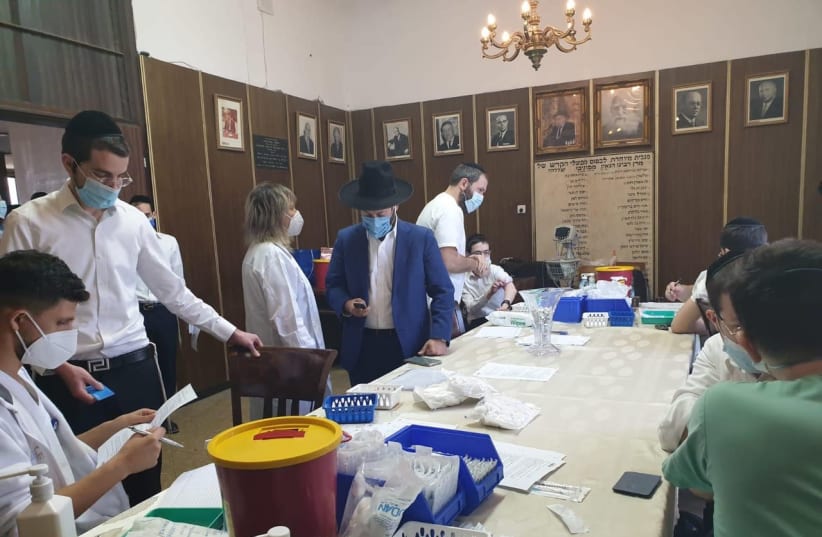 A vaccination drive by the Health Ministry for yeshiva students gets going in the Ponovizeh Yeshiva in Bnei Brak on Thursday afternoon. (photo credit: LEMAANCHEM)