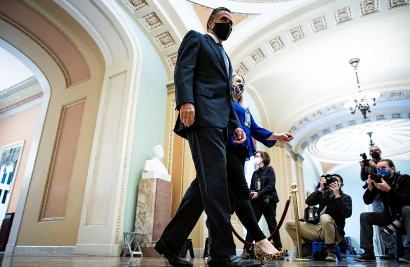 US Senator Mitt Romney (R-UT) walks to the Senate floor on the fifth day of the impeachment trial of former US president Donald Trump, on charges of inciting the deadly attack on the U.S. Capitol, in Washington, US, February 13, 2021 (photo credit: AL DRAGO/REUTERS)