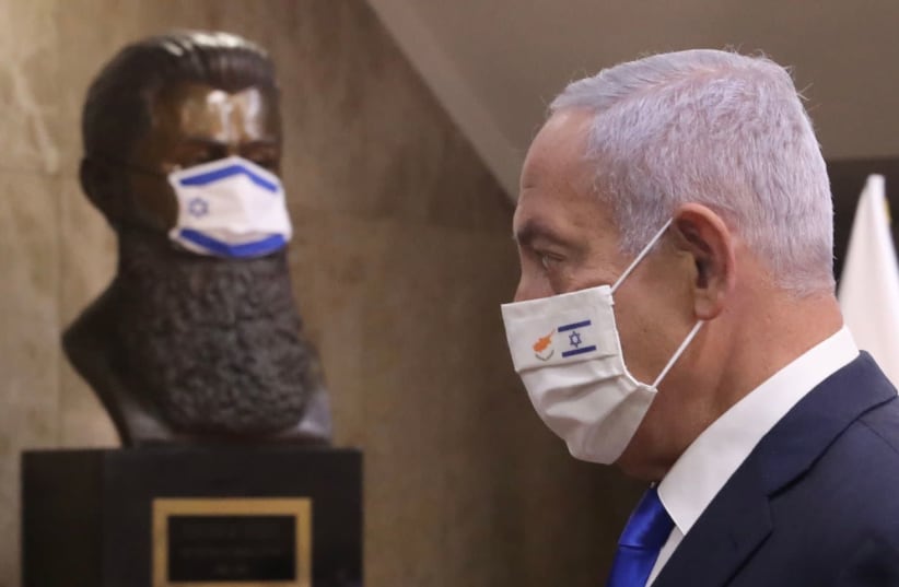 Prime Minister Benjamin Netanyahu (R) in front of a bust of Theodor Herzl. Both are wearing COVID-19 masks.  (photo credit: MARC ISRAEL SELLEM)