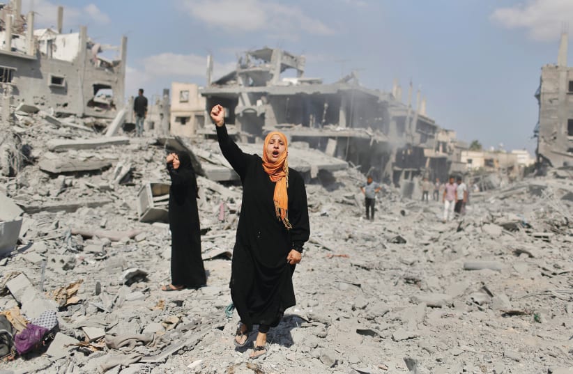 A WOMAN YELLS as she stands near her destroyed house in Beit Hanun, in the northern Gaza Strip in 2014. (photo credit: SUHAIB SALEM / REUTERS)