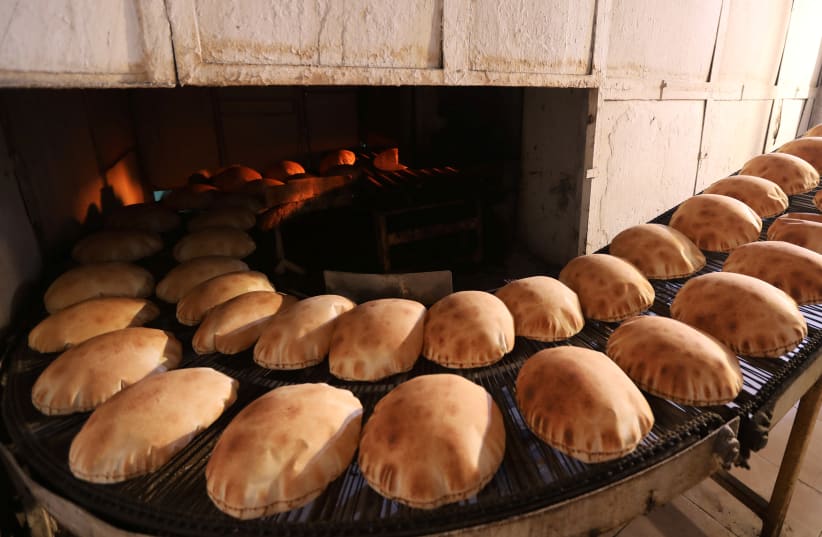 Freshly baked bread cools at a bakery in Beirut, Lebanon June 30, 2020. (photo credit: MOHAMED AZAKIR / REUTERS)