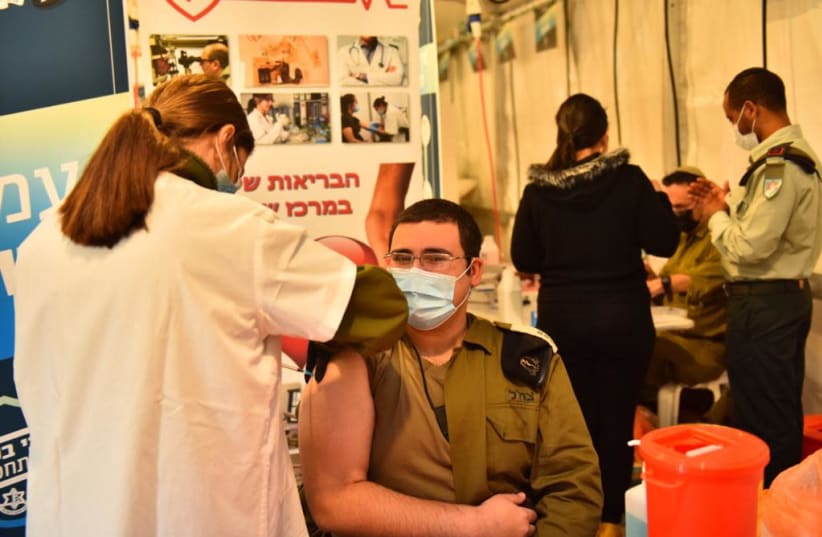 An IDF soldier is seen getting the coronavirus vaccine. (photo credit: IDF SPOKESPERSON'S UNIT)
