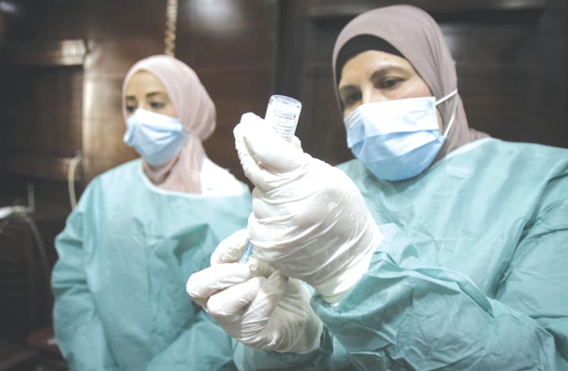 PALESTINIAN HEALTH WORKERS at a hospital in Nablus, where health workers were vaccinated against the coronavirus disease, after the delivery of vaccine doses from Israel earlier this month. (photo credit: NASSER ISHTAYEH/FLASH90)