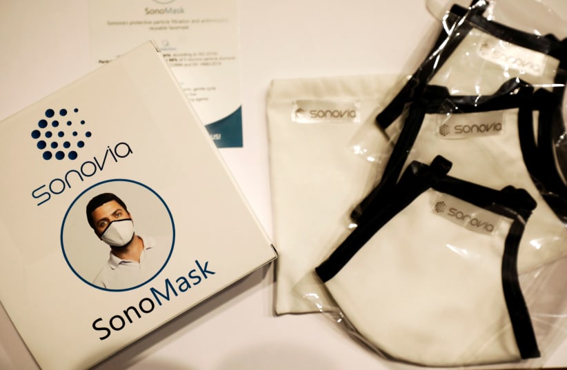 Packaging of Israel's Sonovia Ltd's washable and reusable antiviral masks, which the company says can help stop the spread of the coronavirus disease (COVID-19), is displayed along with the masks at the company laboratory, in Ramat Gan, Israel May 17, 2020.  (photo credit: AMIR COHEN/REUTERS)