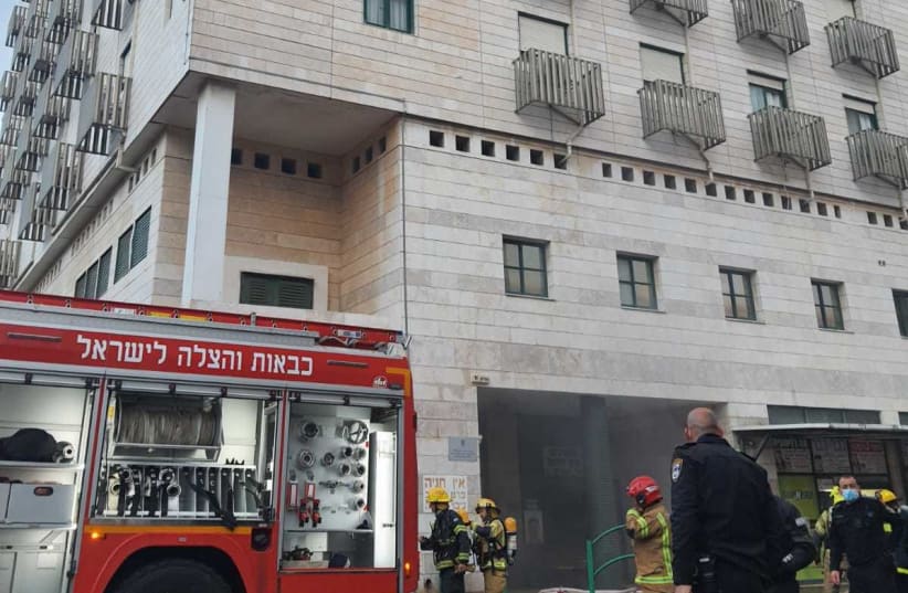 Firefighters work to put out a fire and evacuate residents from a nursing home on Gordon street in Hadera. (photo credit: FIRE AND RESCUE SERVICE)