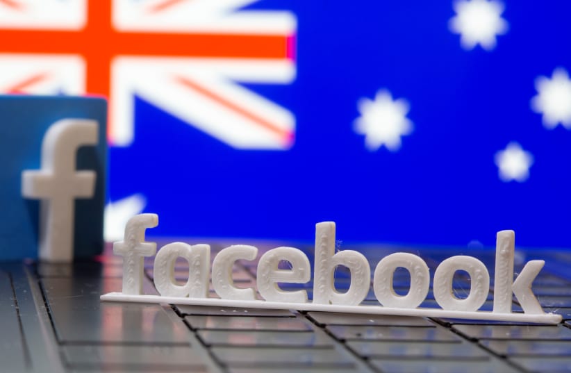 A 3D printed Facebook logo is seen in front of displayed Australia's flag in this illustration photo taken February 18, 2021 (photo credit: REUTERS/DADO RUVIC/ILLUSTRATION)