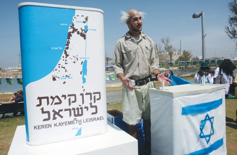 THE FAMOUS KKL-JNF blue box is promoted by a rather tall and lanky David Ben-Gurion impersonator on Independence Day in Tel Aviv in 2009. (photo credit: RONI SCHUTZER/FLASH90)