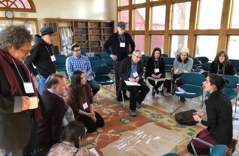 Mati Esther Engel, bottom right, a performance artist, ritualist and spiritual care practitioner, speaks to participants at a gathering of Kenissa, a network of Jewish “communities of meaning,” held in March 2020 in Falls Village, Conn.  (photo credit: KENISSA)