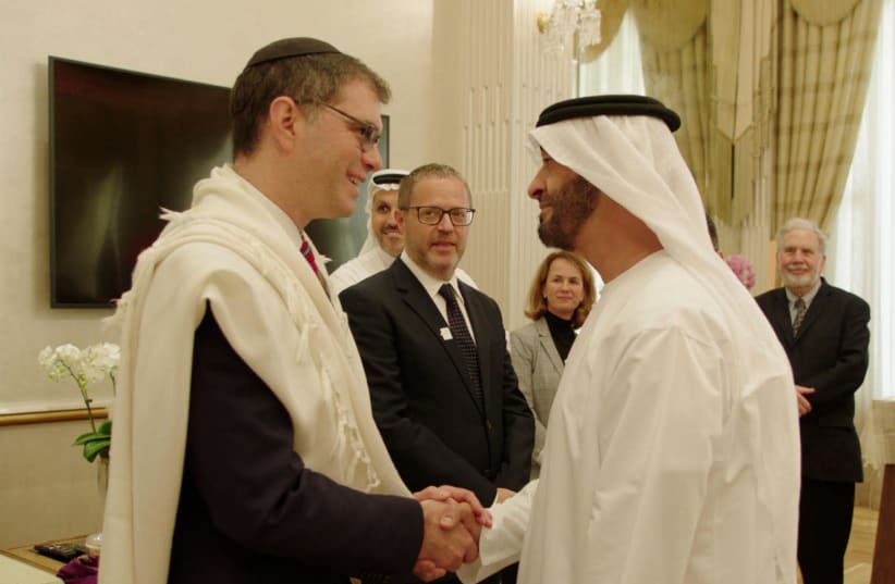 Chief Rabbi of the Jewish Council of the Emirates Rabbi Yehuda Sarna meets with Crown Prince of Abu Dhabi Sheikh Mohammed bin Zayed bin Sultan Al Nahyan at ceremony in 2019 in which the crown prince was given a Torah scroll dedicated to his father’s memory.  (photo credit: RELIGION MEDIA COMPANY)