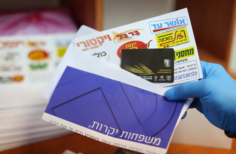 The envelope containing the 'food debit cards' that families in need will receive to address the economic crisis they have been dealing with due to the coronavirus pandemic, February 22, 2021.  (photo credit: Courtesy)