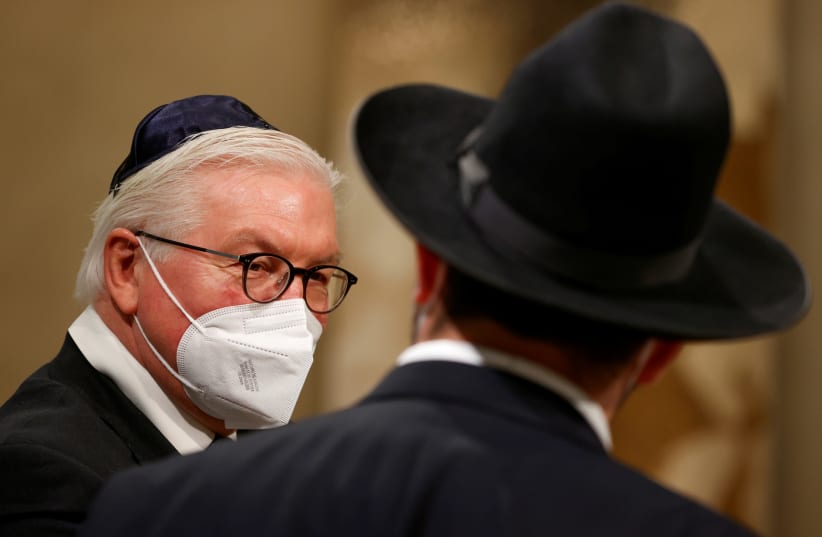 German President Frank-Walter Steinmeier speaks with a rabbi following a ceremony to complete the historic Sulzbach Torah Scroll from 1792, rediscovered in 2013 and just restored, on the 76th anniversary of the liberation of Nazi Germany's Auschwitz death camp, on International Holocaust Remembrance (photo credit: ODD ANDERSEN/POOL VIA REUTERS)