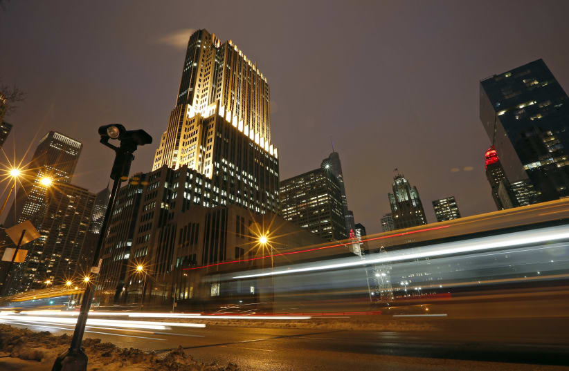Cars cause streaks of lights as they drive past a red light camera in downtown Chicago (photo credit: JIM YOUNG / REUTERS)