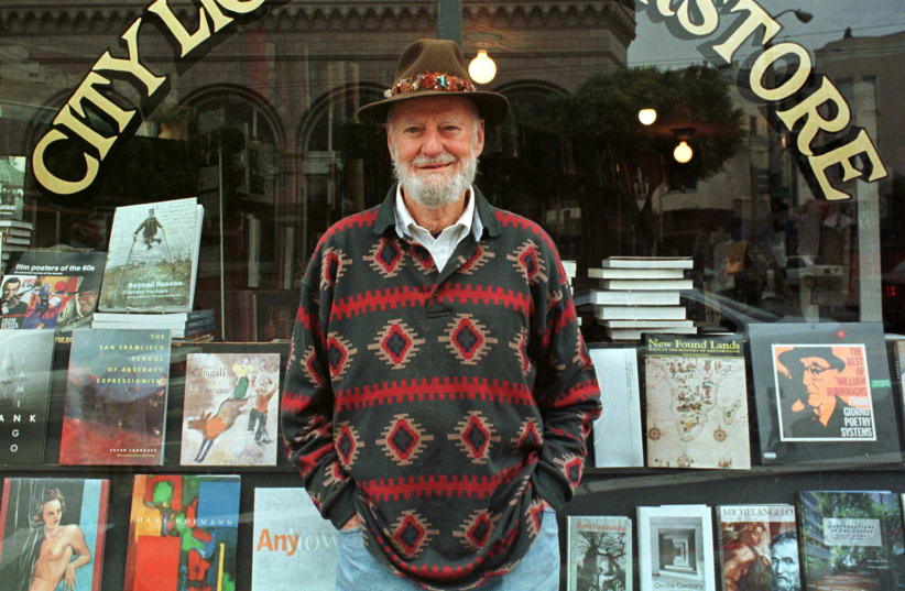 Lawrence Ferlinghetti stands outside his bookstore in San Francisco (photo credit: REUTERS)