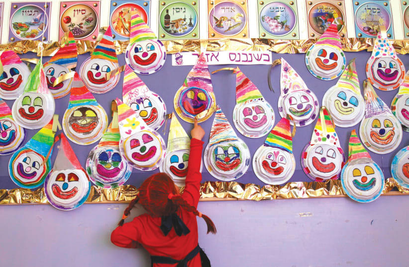 Making merry at a school Purim party in years past (photo credit: NATI SHOHAT/FLASH90)