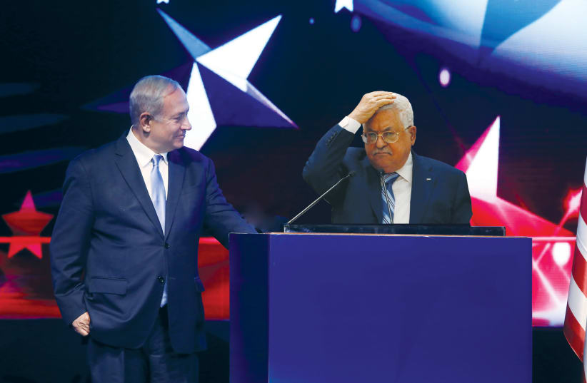 MAHMOUD ABBAS covers his head as Prime Minister Benjamin Netanyahu recites the Motzei at their joint press conference. (photo credit: COMPOSITE PHOTO BY OLGA LEVI/REUTERS/FLASH90/WIKIMEDIA COMMONS)