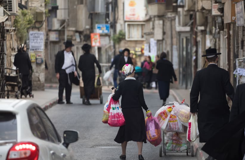A typical street scene in the bustling modern-day shtetl of Jerusalem's Mea She'arim neighborhood. (photo credit: YONATAN SINDEL/FLASH90)