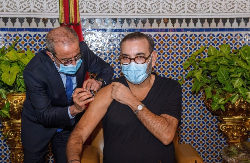 Morocco's King Mohammed VI receives a dose of a COVID-19 vaccine at the Royal Palace in Fez, Morocco as he inaugurates Morocco's national coronavirus vaccination campaign, Jan 28, 2021 (photo credit: MOROCCAN ROYAL PALACE PRESS SERVICE/HANDOUT VIA REUTERS)