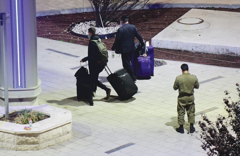 ISRAELI PASSENGERS arrive home after an emergency flight to Ben-Gurion Airport on February 3. (photo credit: TOMER NEUBERG/FLASH90)